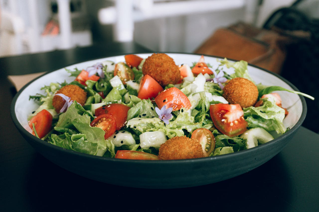 Tasty salad with crispy falafel, fresh veggies, and tomatoes for a healthy meal.